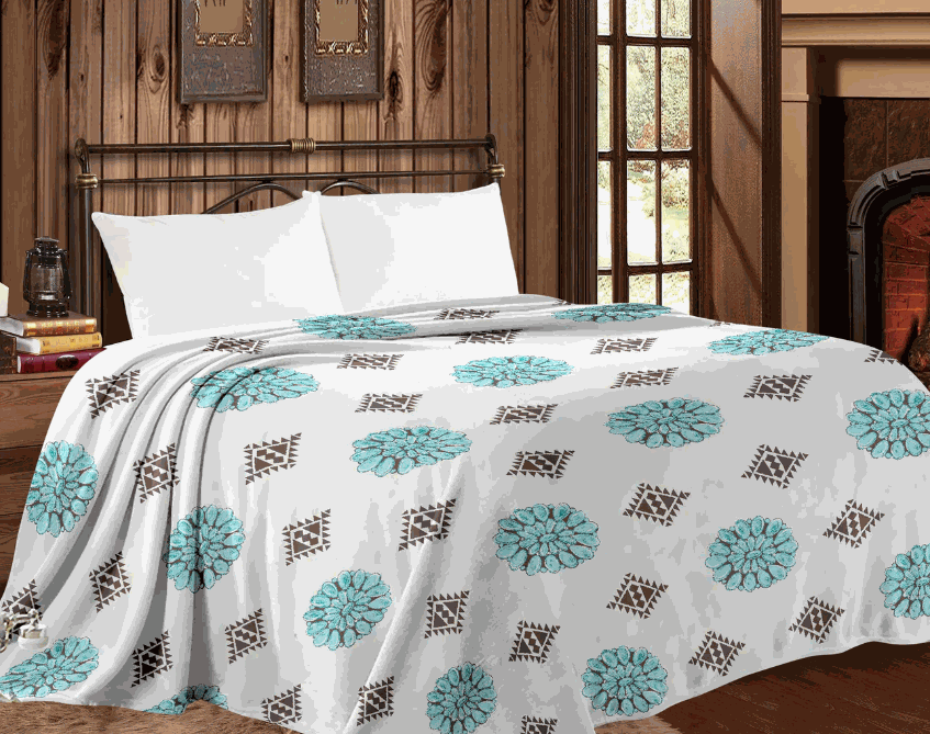 Mia Throw Blanket with western conchos design on bed in cozy room setting.