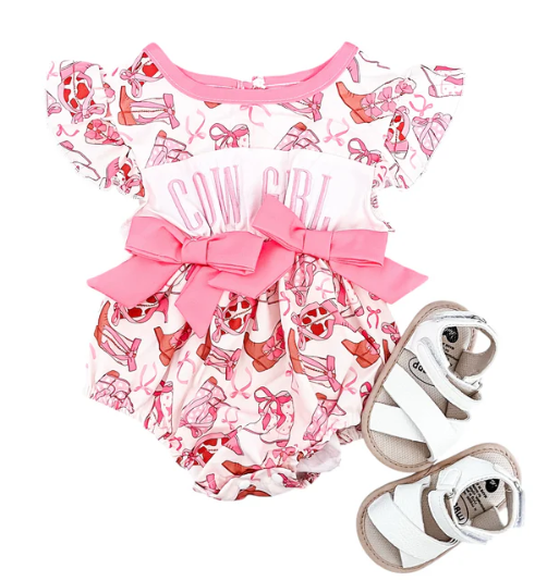 Child wearing a playful Cow Girl Embroidered Romper with charming embroidery and comfy fit outdoors