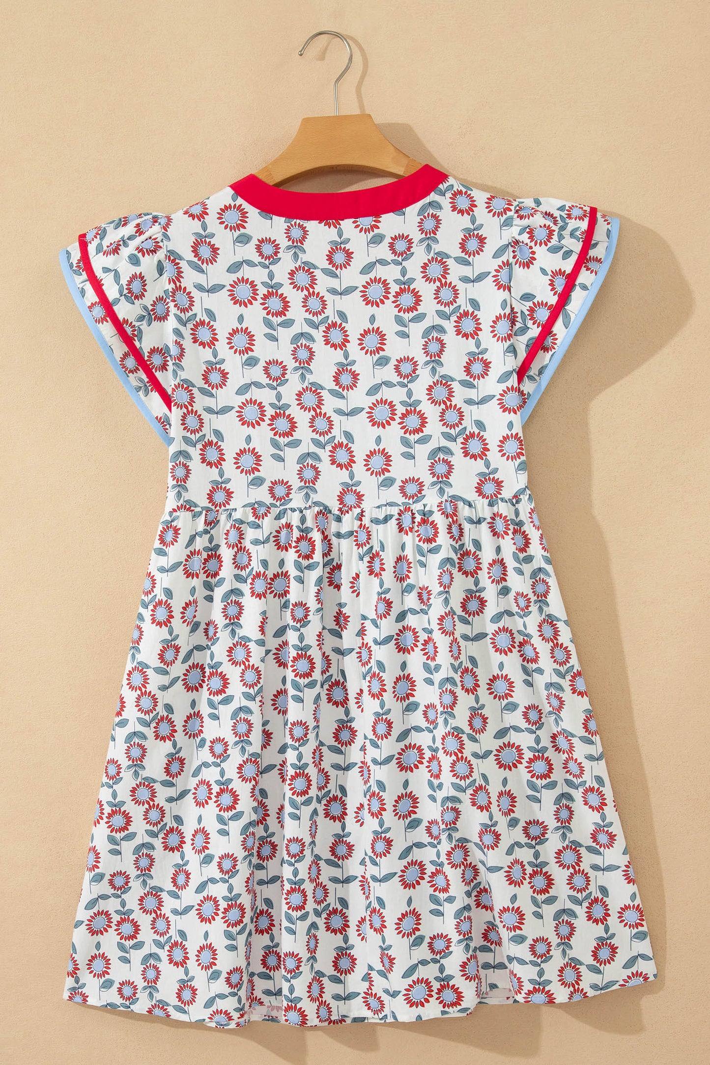 Red floral contrast trim flutter sleeve mini dress - lifestyle shot on model showing full summer styling