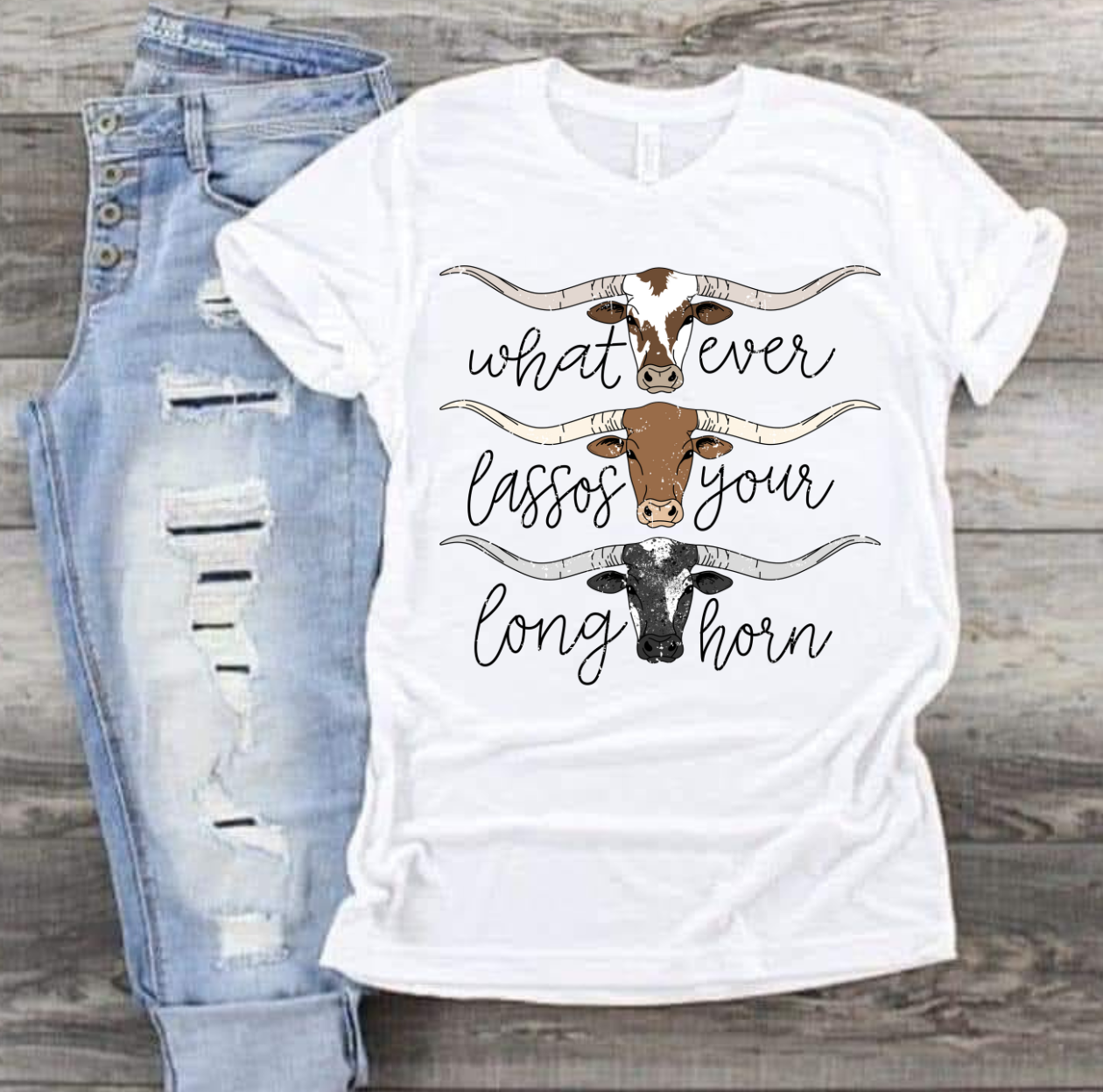 Tshirt with "Whatever Lassos Your Longhorn" design featuring three stylized longhorns.