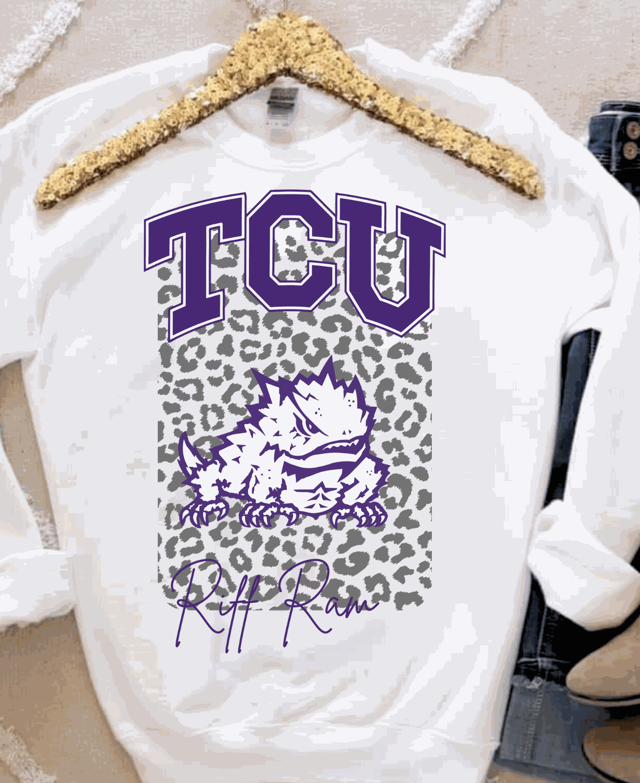 TCU Riff Ram sweatshirt with purple lettering and leopard print background.