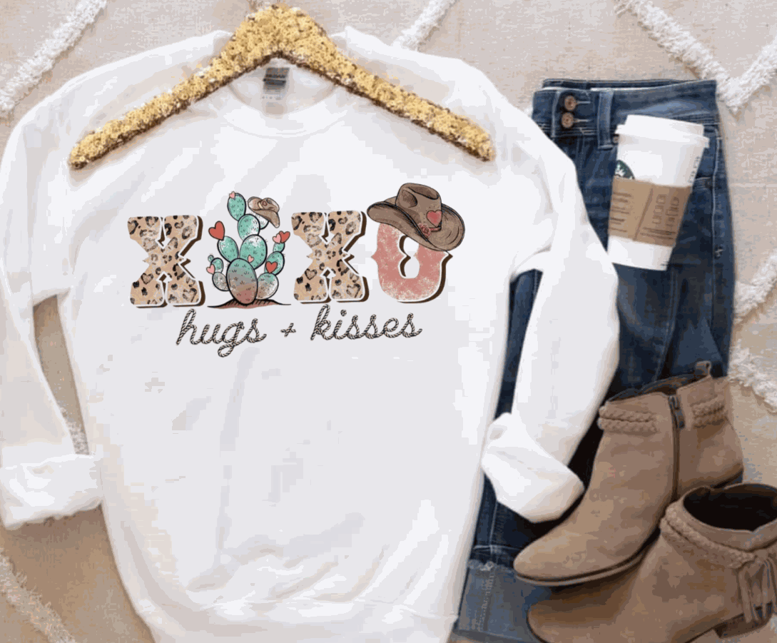 Hugs & Kisses Gildan sweatshirt, 50/50 blend, displayed with jeans and boots.