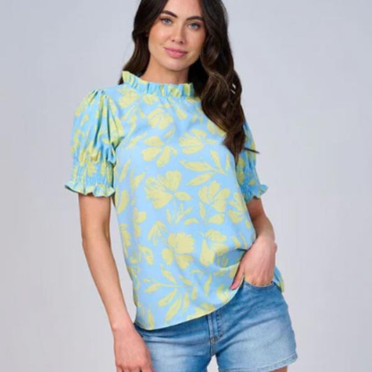 Short-sleeved mock neck leaf print blouse in yellow and light blue with puffed sleeves and ruffled neckline.