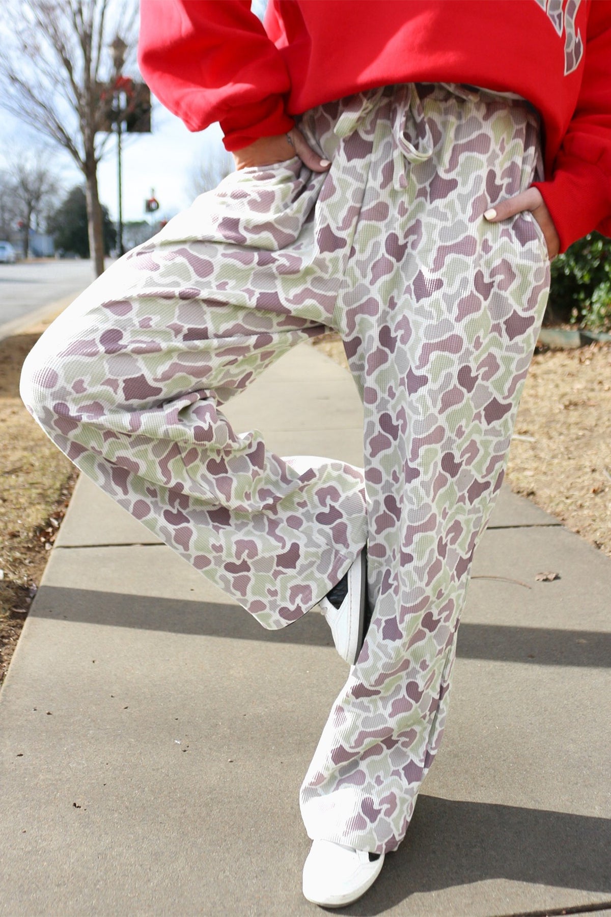 Camo Drawstring Wide Leg Pants - model front view styled with red sweatshirt