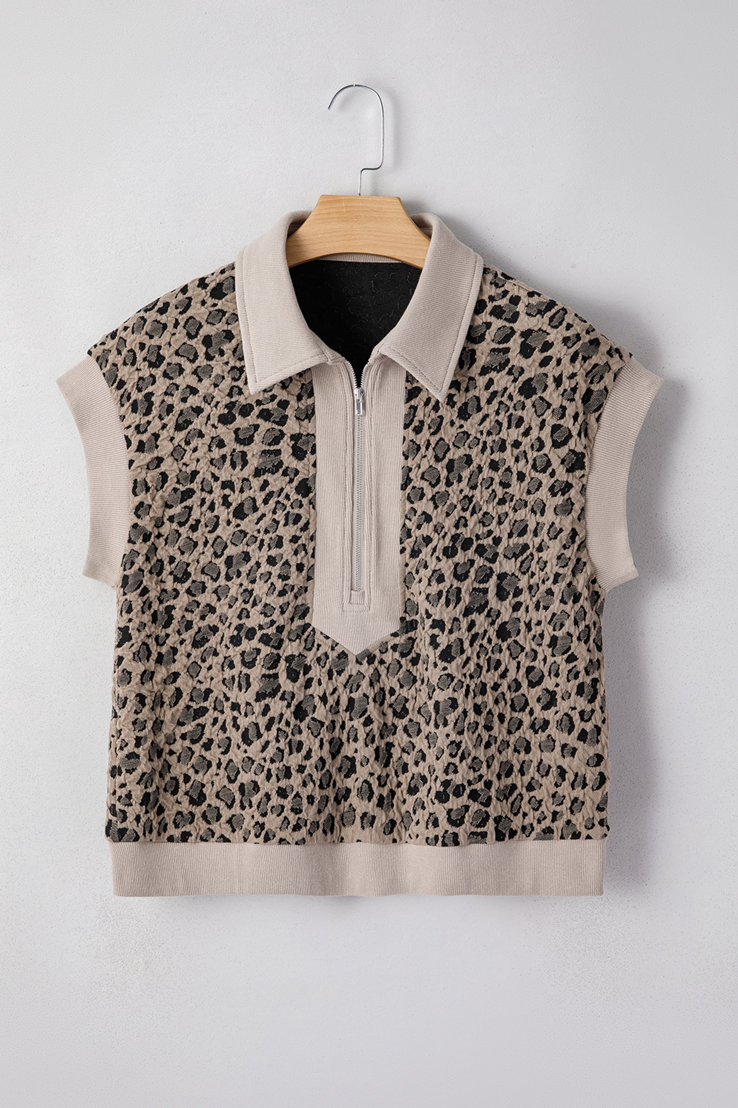 Beige leopard jacquard knit zip collar top - close-up of ribbed hem band and jacquard knit fabric