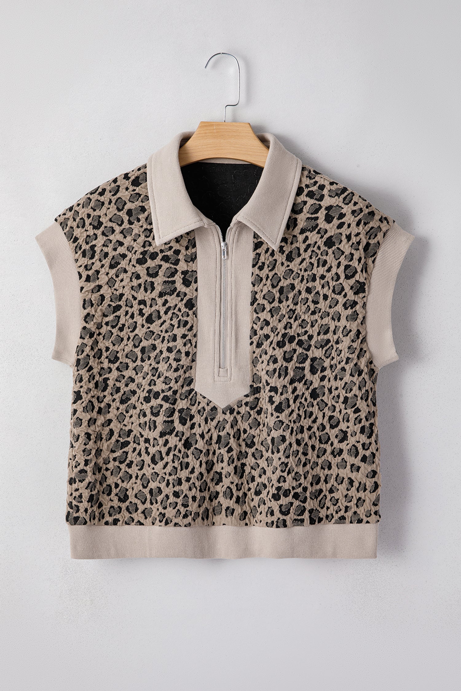 Beige leopard jacquard knit zip collar top - close-up of ribbed hem band and jacquard knit fabric