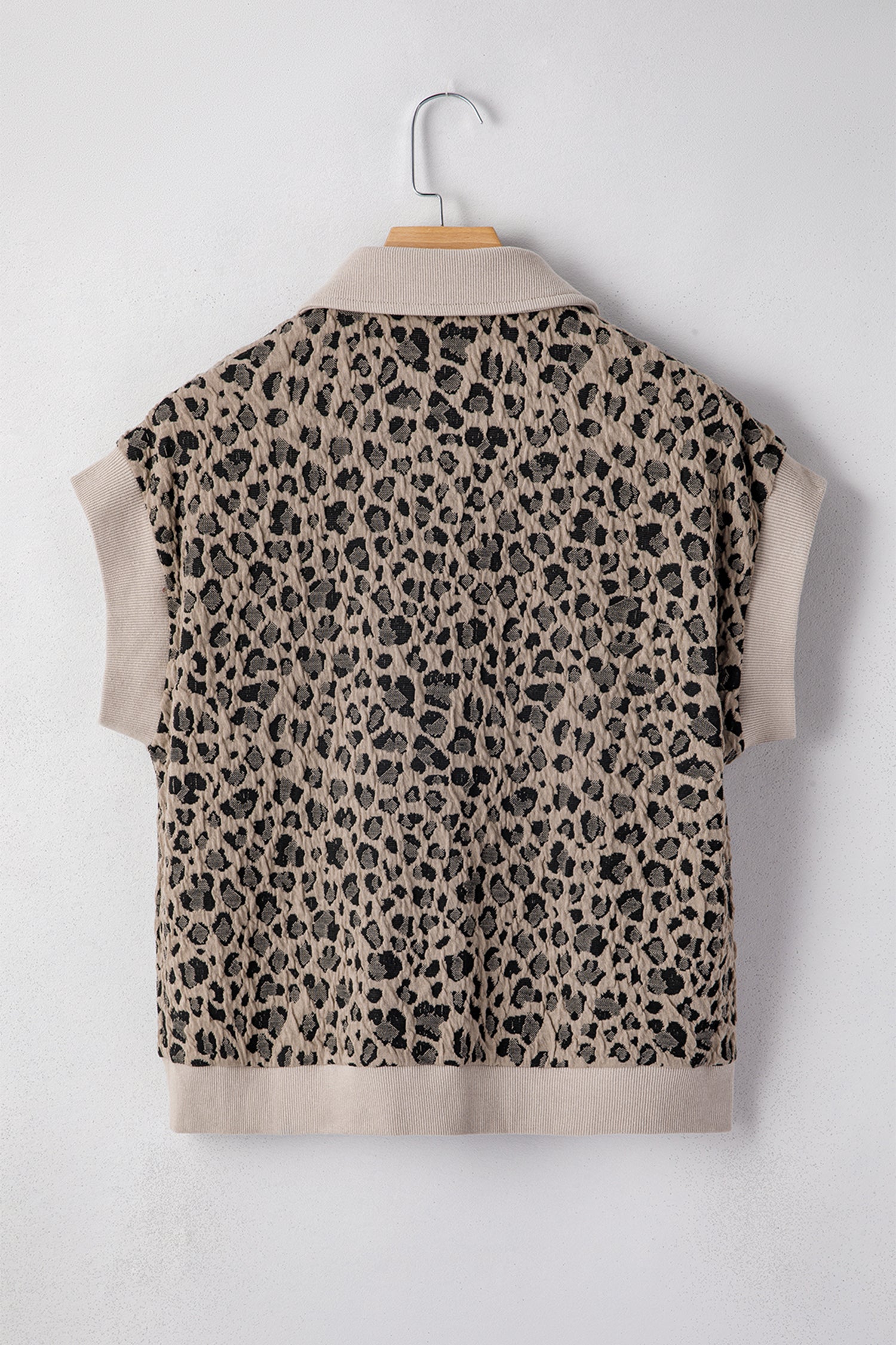 Beige leopard jacquard knit zip collar top - close-up of leopard jacquard knit fabric texture detail