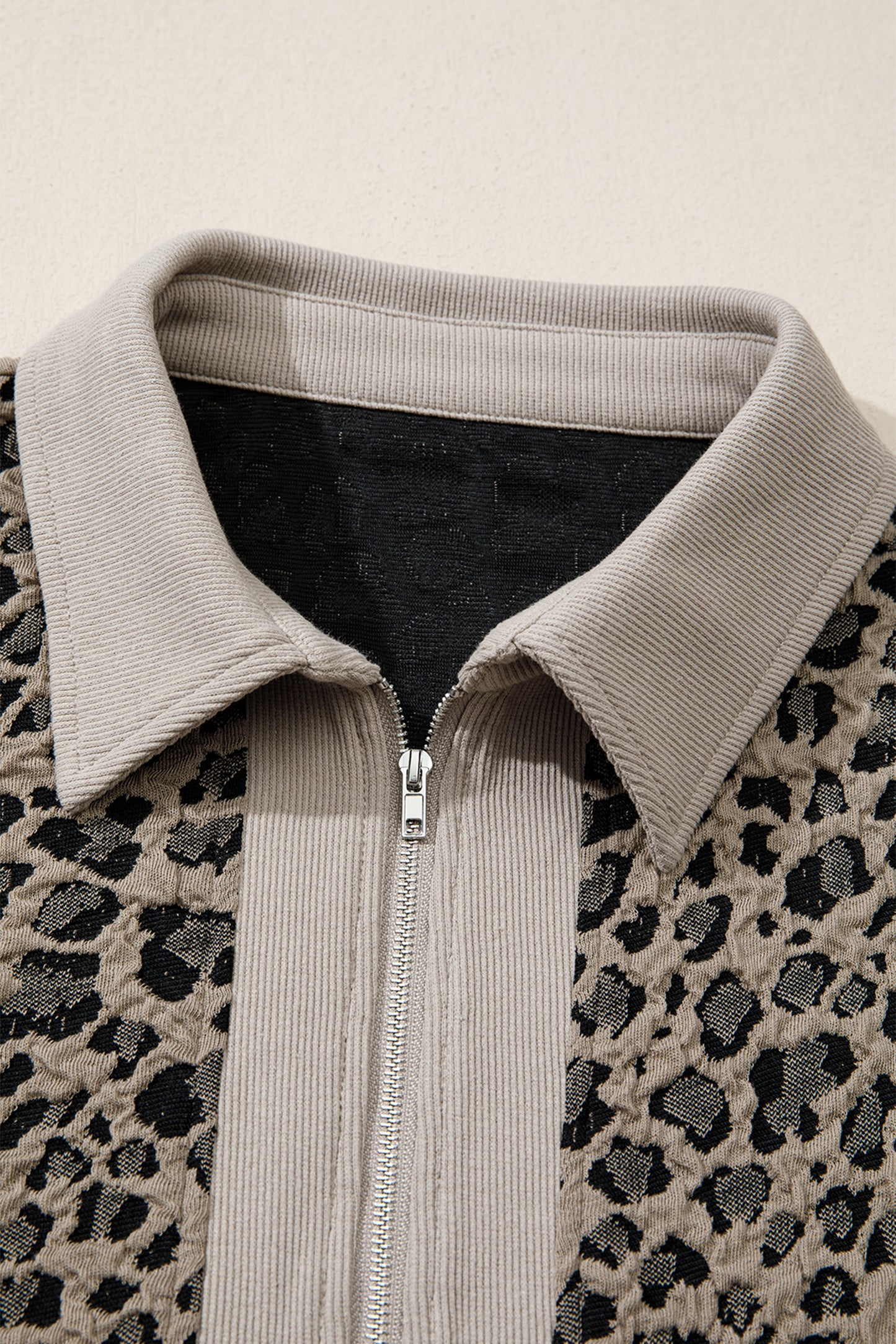 Beige leopard jacquard knit zip collar top - front on model showing relaxed fit and zip collar styling
