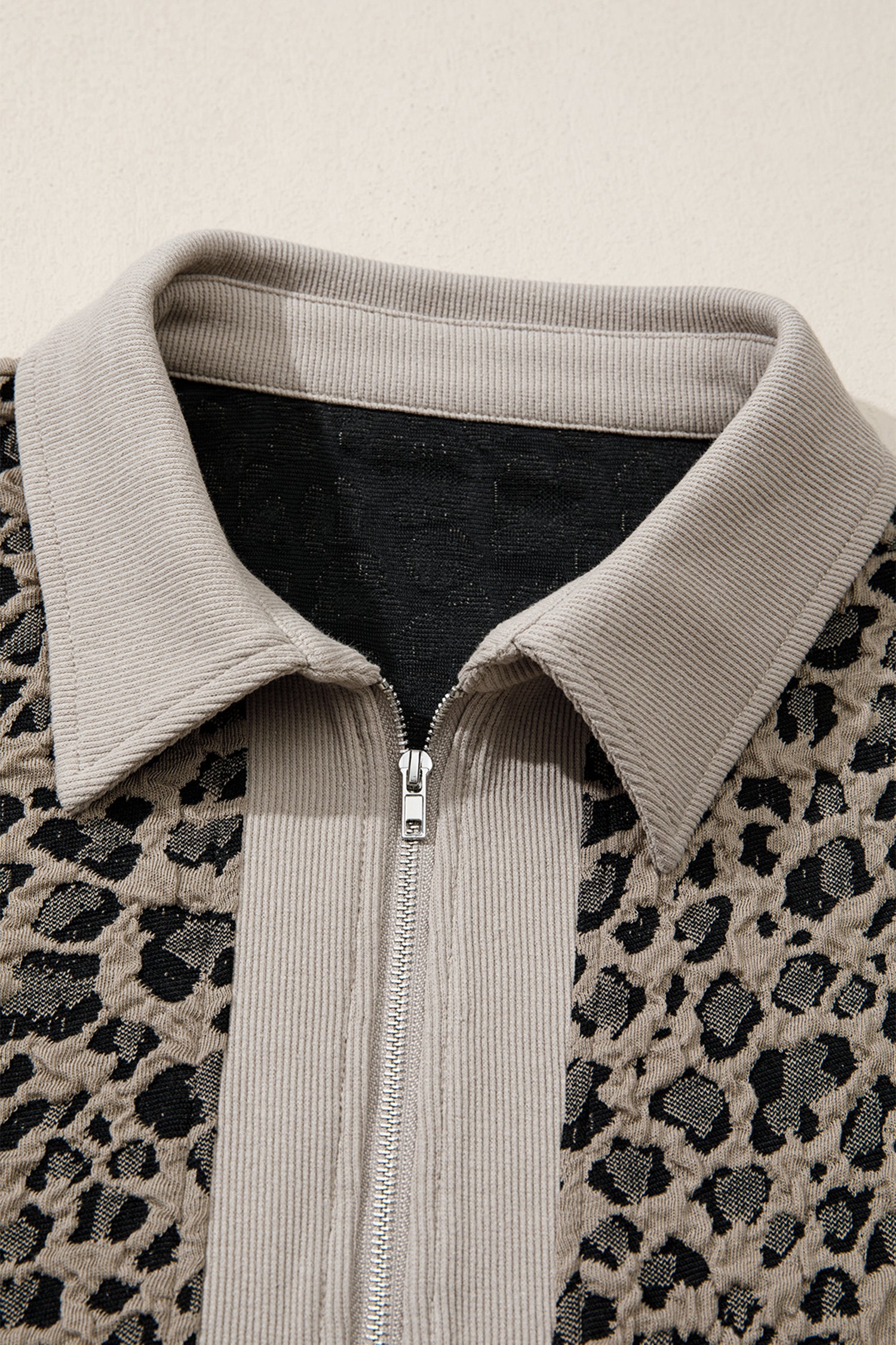Beige leopard jacquard knit zip collar top - front on model showing relaxed fit and zip collar styling