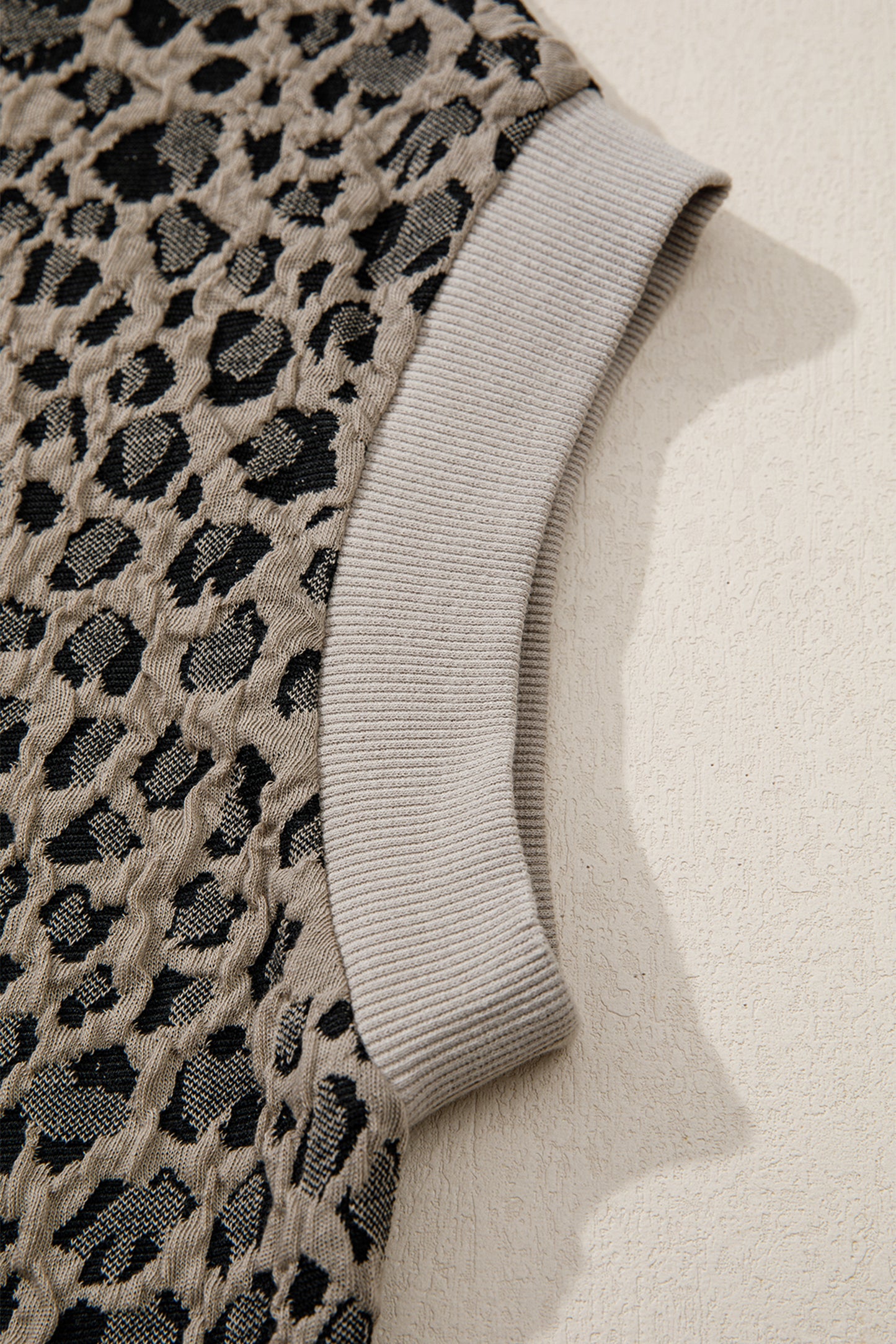 Beige leopard jacquard knit zip collar top - front on model with wide-leg trousers showing full outfit
