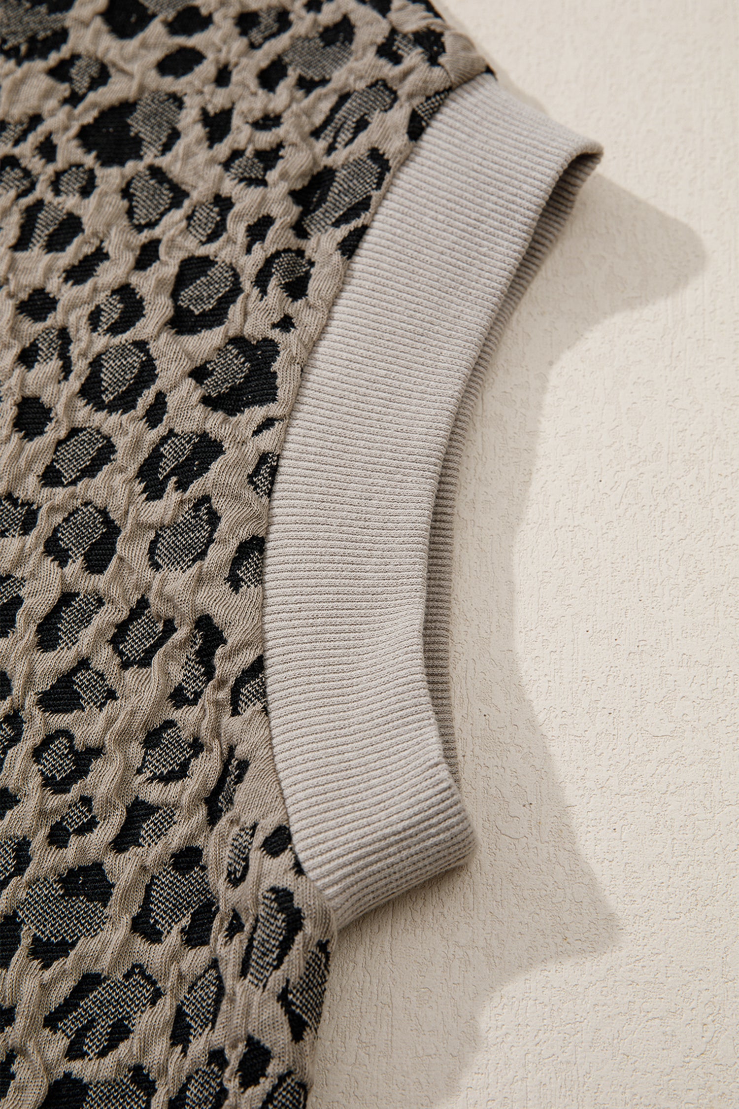 Beige leopard jacquard knit zip collar top - front on model with wide-leg trousers showing full outfit