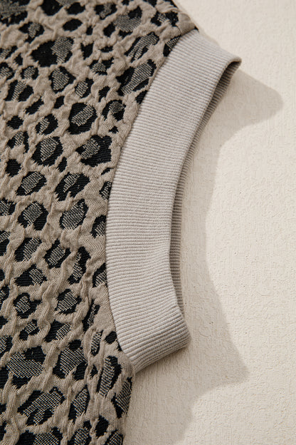 Beige leopard jacquard knit zip collar top - front on model with wide-leg trousers showing full outfit