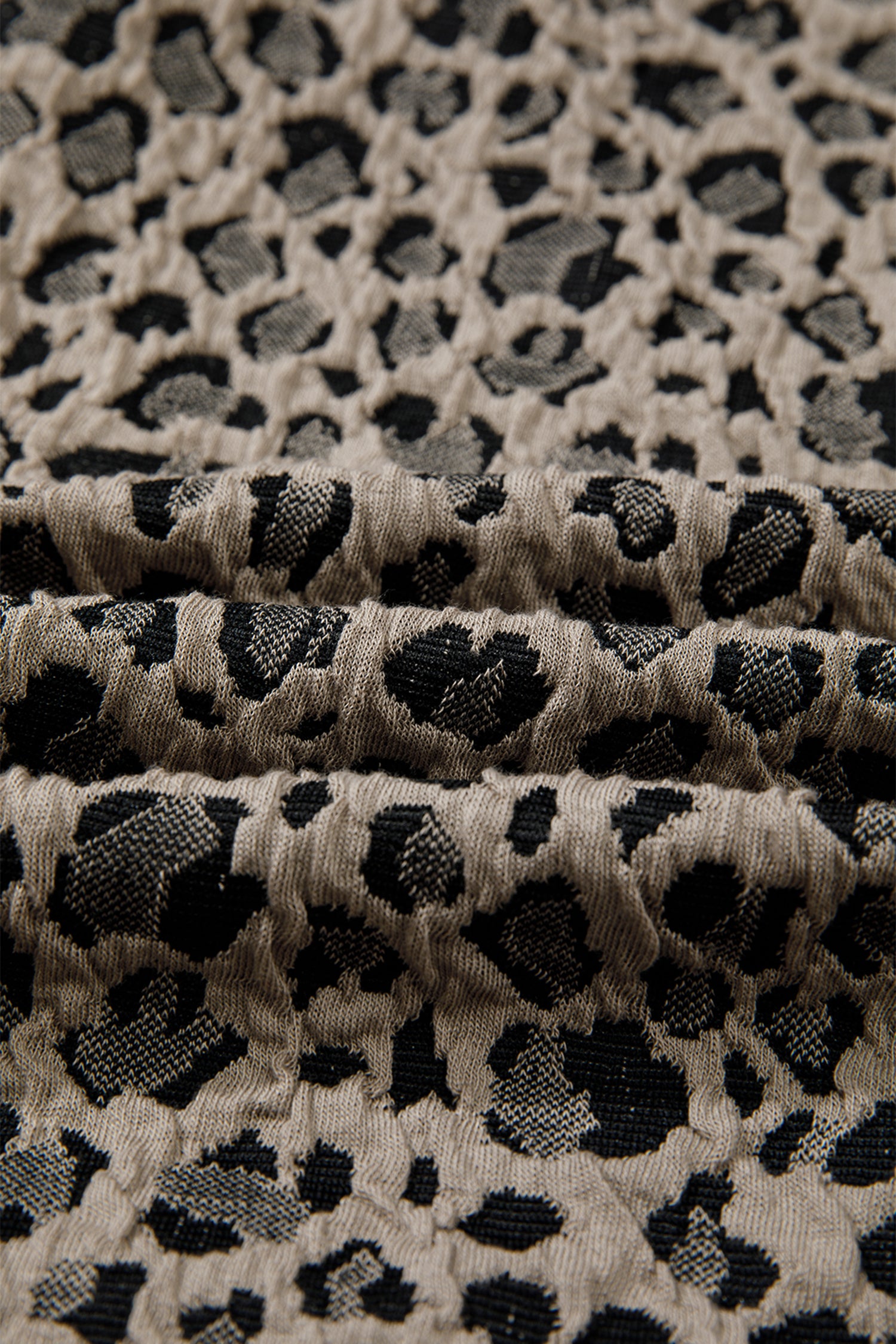 Beige leopard jacquard knit zip collar top - lifestyle shot on model showing elevated sporty-chic styling