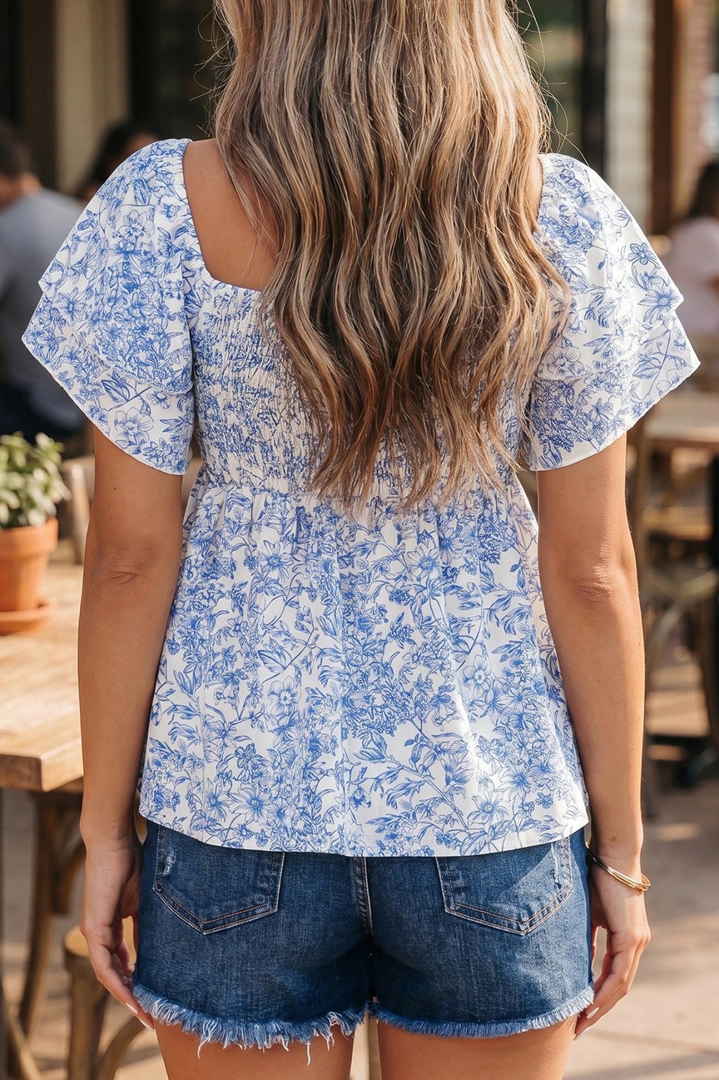 Blue toile floral smocked babydoll blouse - front detail on model