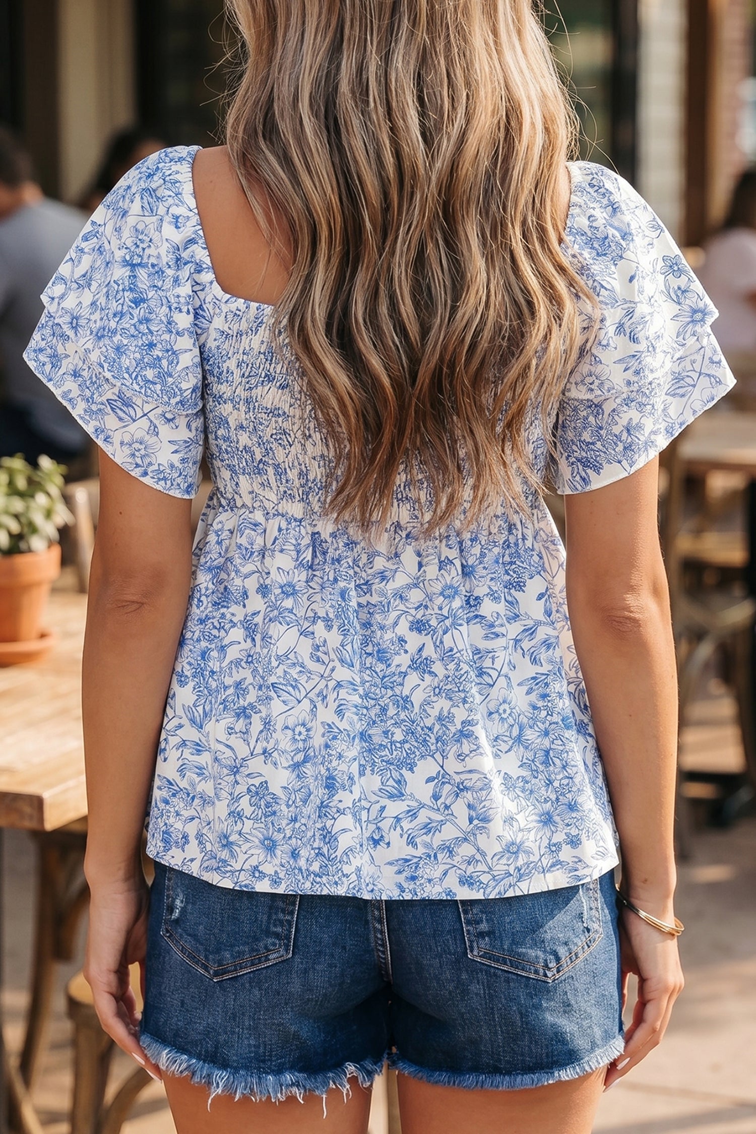 Blue toile floral smocked babydoll blouse - front detail on model