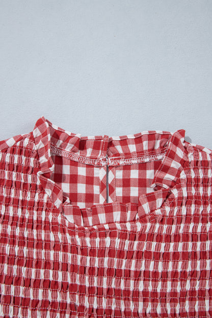 Ruffled neckline and shirred front detail of red plaid top