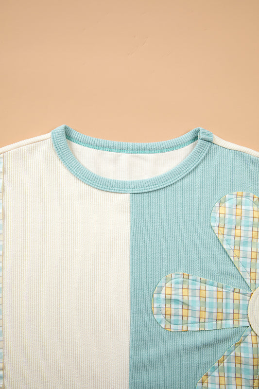 Full front view of light blue daisy plaid patchwork top