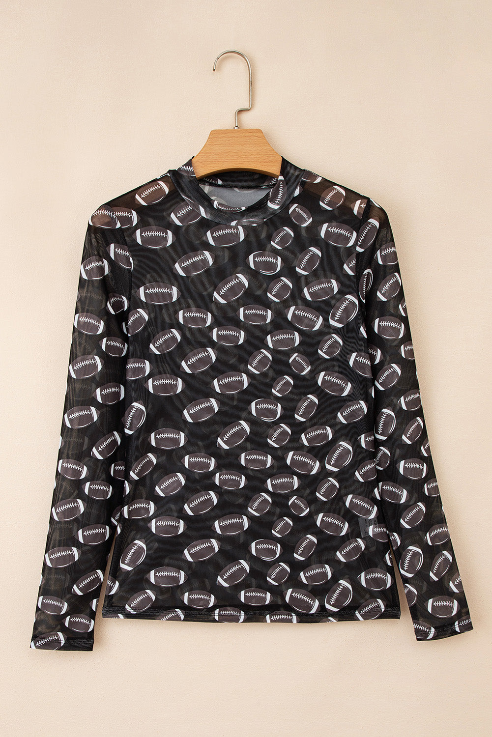 Black football-print mesh top styled with denim