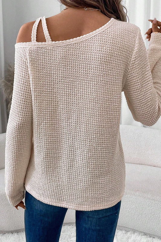 Cream waffle knit cold shoulder top - front flat lay on hanger showing full silhouette and asymmetric neckline