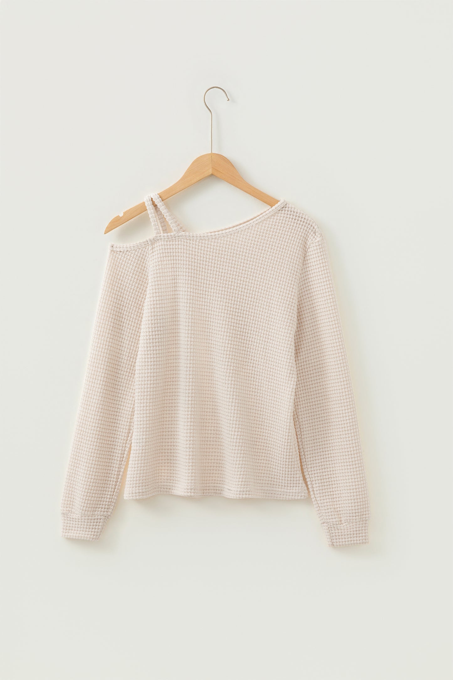 Cream waffle knit cold shoulder top - close-up of waffle knit fabric texture draped