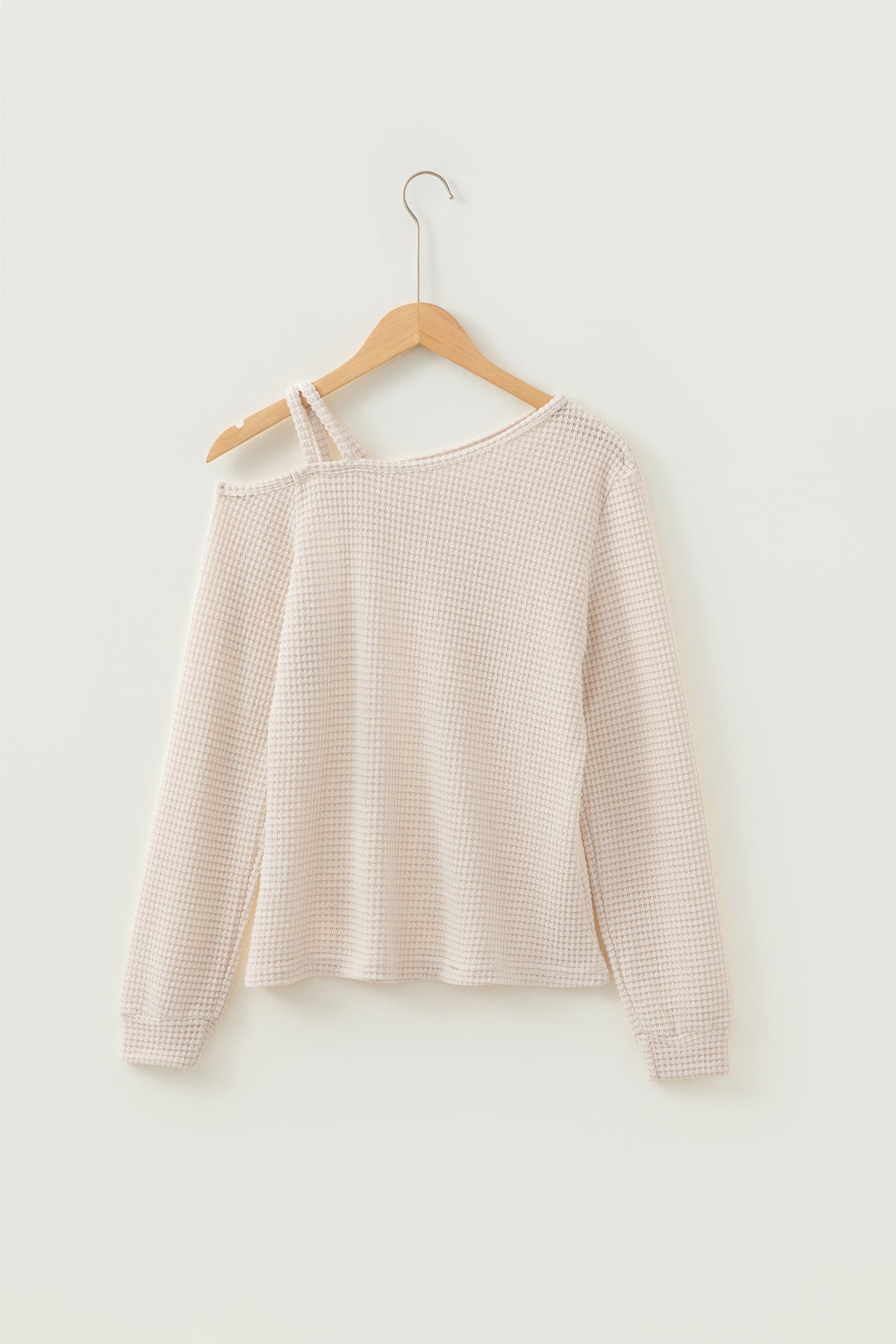 Cream waffle knit cold shoulder top - close-up of waffle knit fabric texture draped