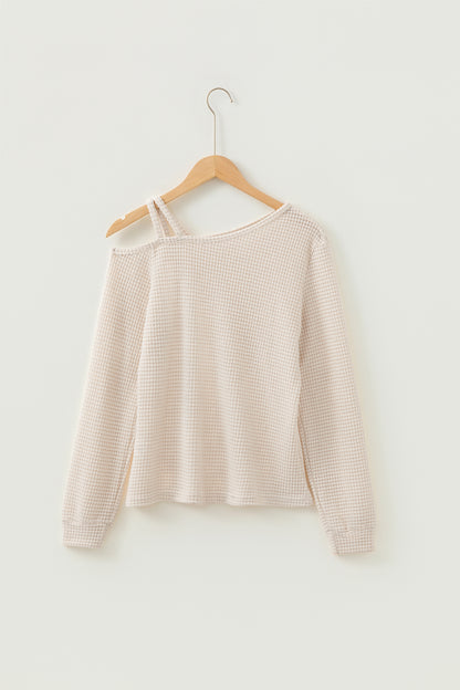Cream waffle knit cold shoulder top - close-up of waffle knit fabric texture draped