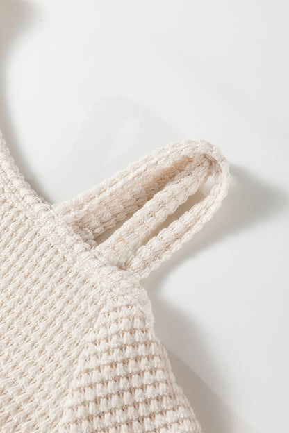 Cream waffle knit cold shoulder top - angled view on model showing cold shoulder and ribbed cuff