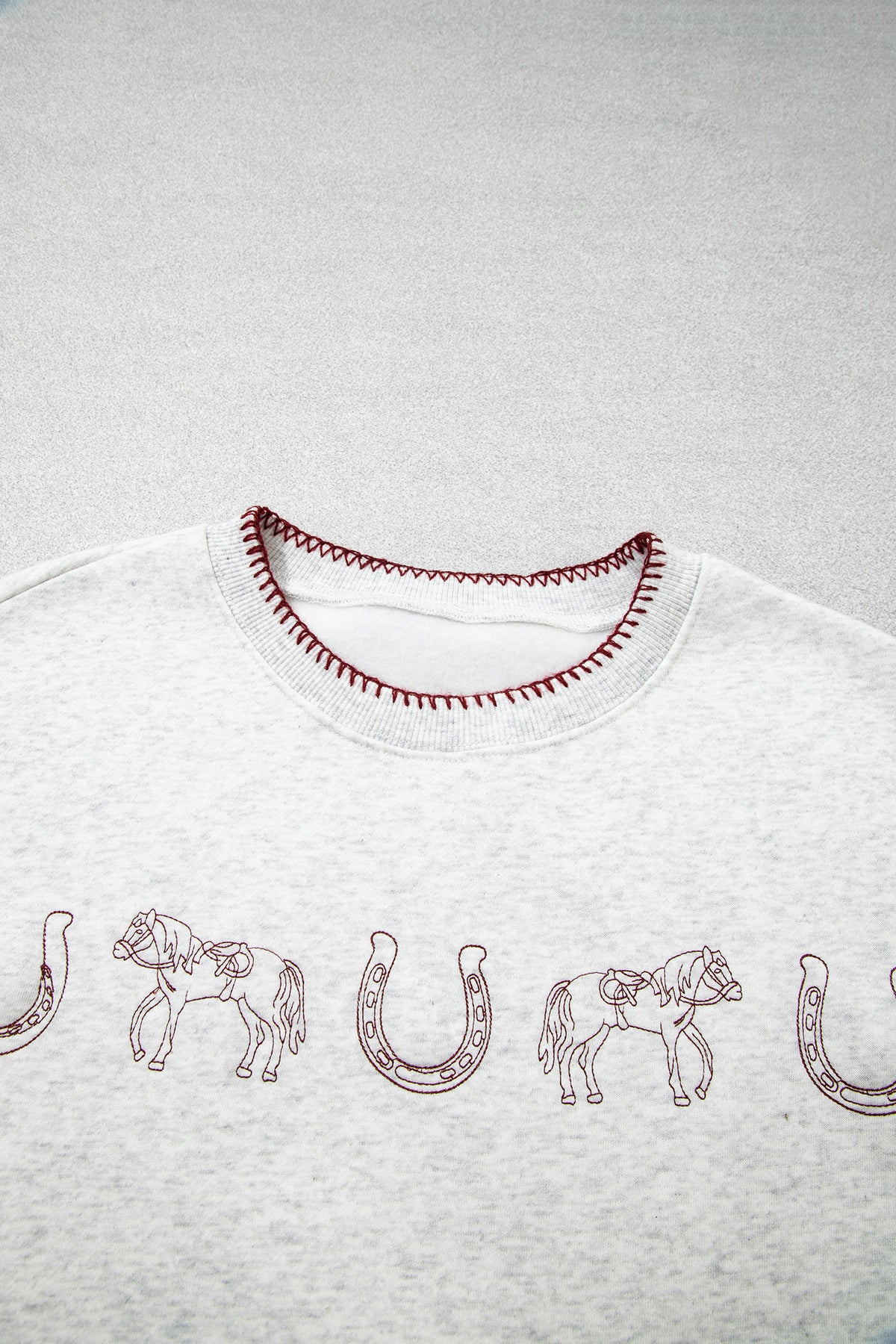 Horse embroidery and contrast neckline stitching detail