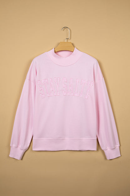 Full front view of pink Stay Salty mock neck sweatshirt
