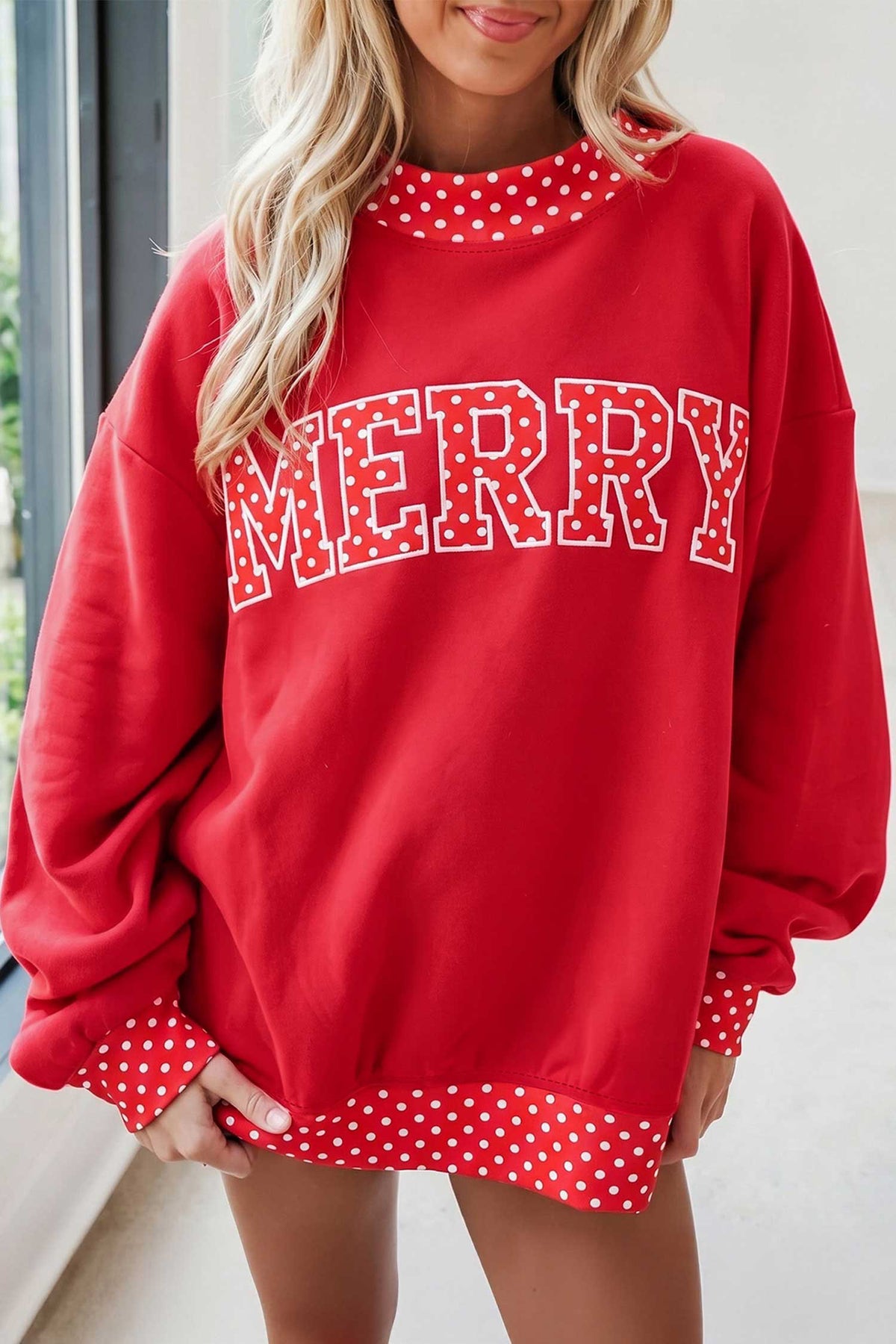 Tomato-red MERRY polka-dot trim sweatshirt styled on a model