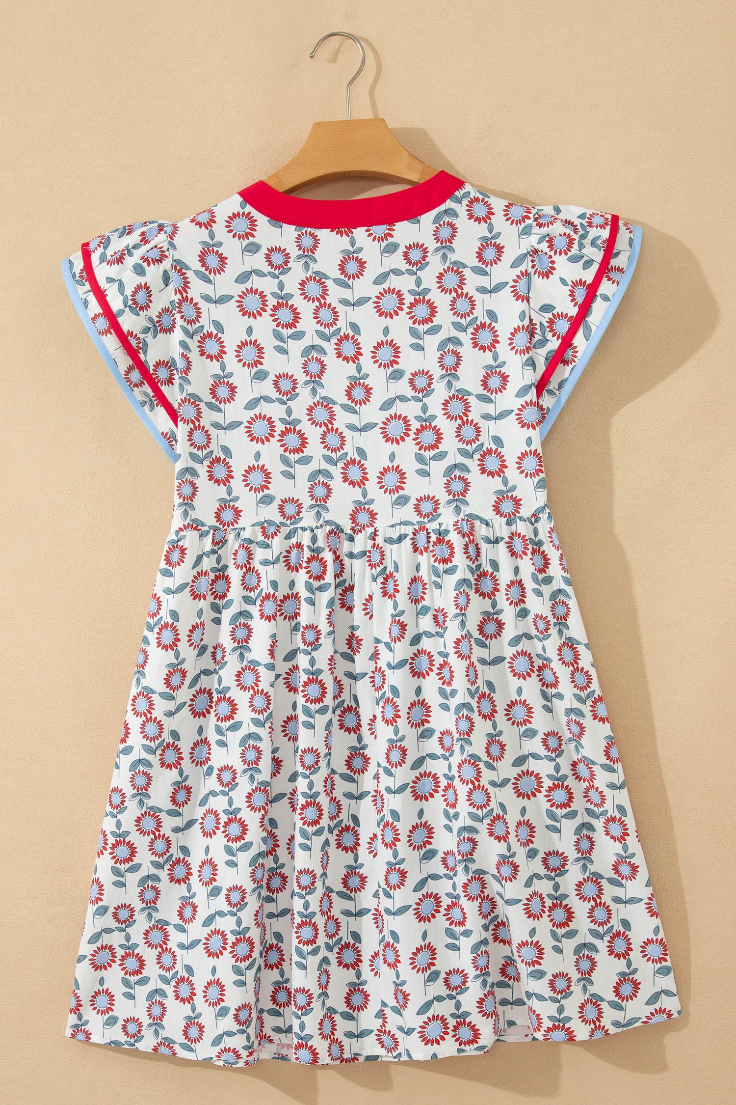 Red floral contrast trim flutter sleeve mini dress - lifestyle shot on model showing full summer styling