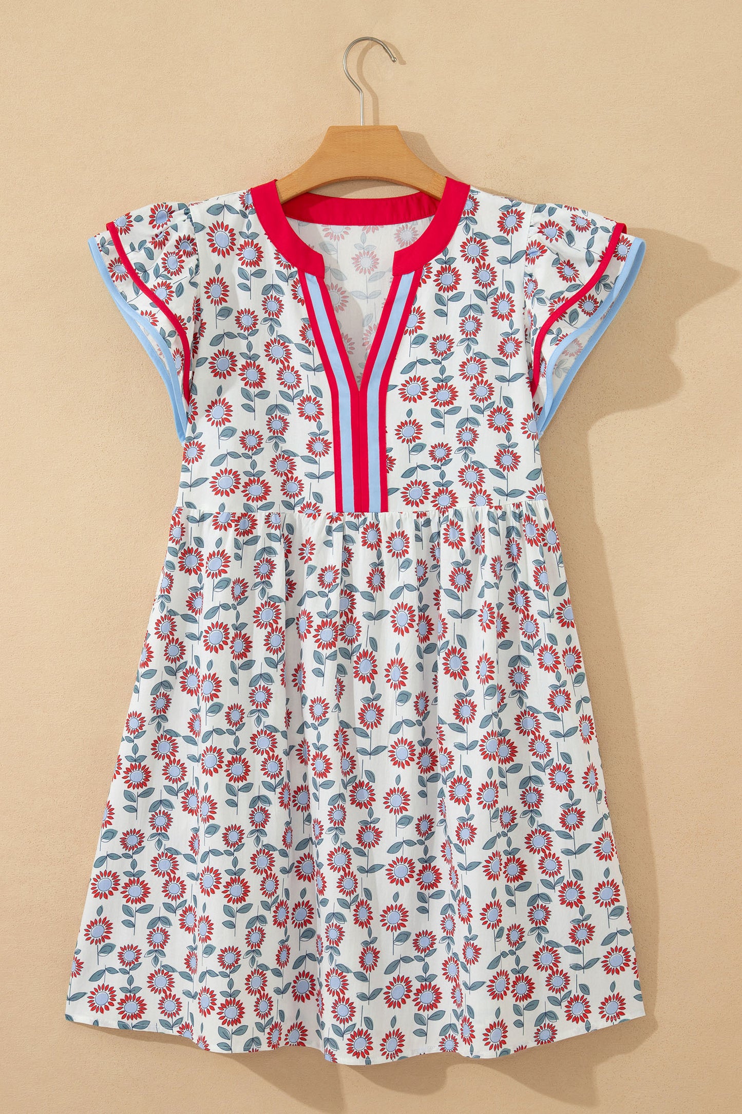 Red floral contrast trim flutter sleeve mini dress - angled view on model showing flutter sleeve and contrast blue trim detail