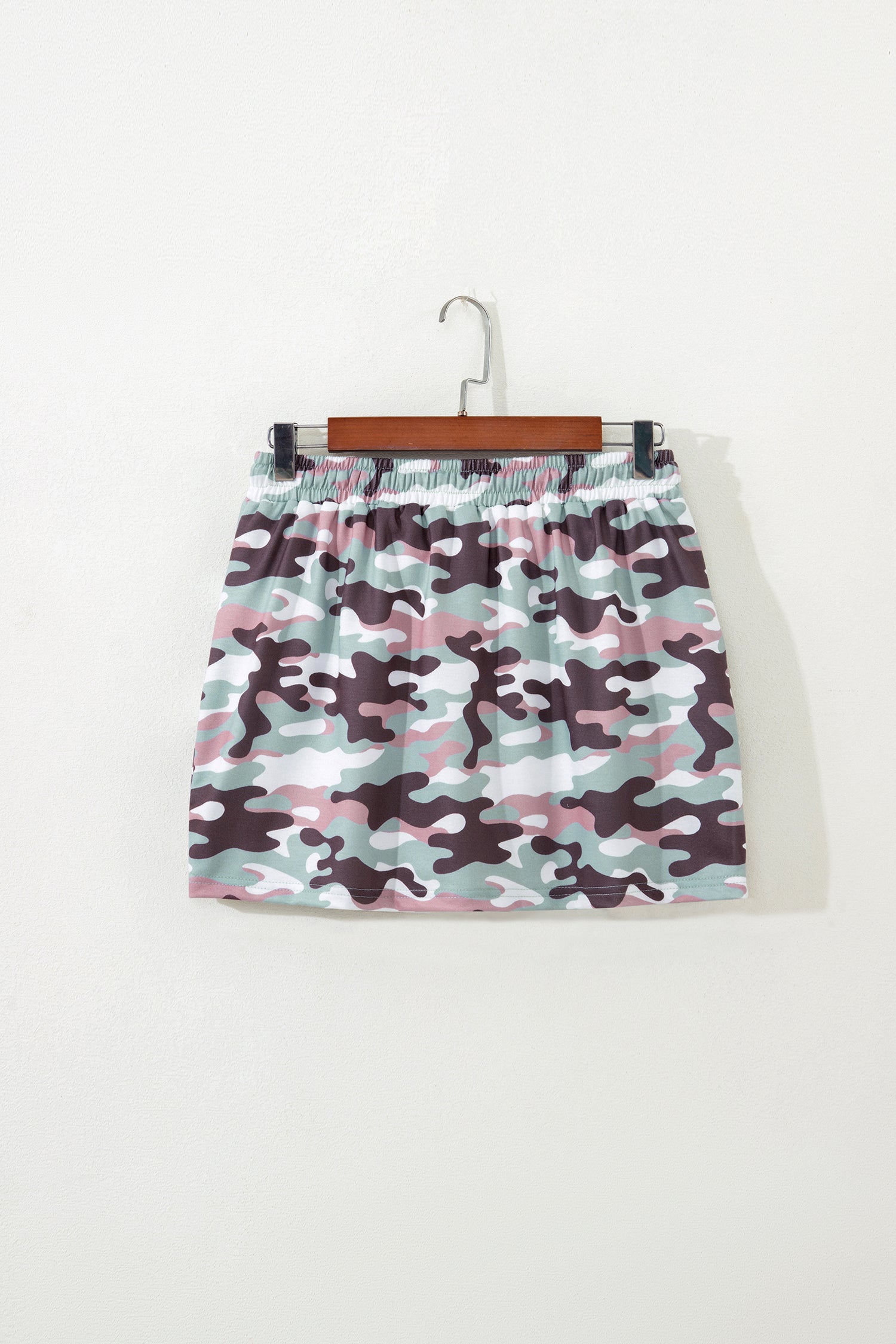 Green camouflage mini skort back view on hanger