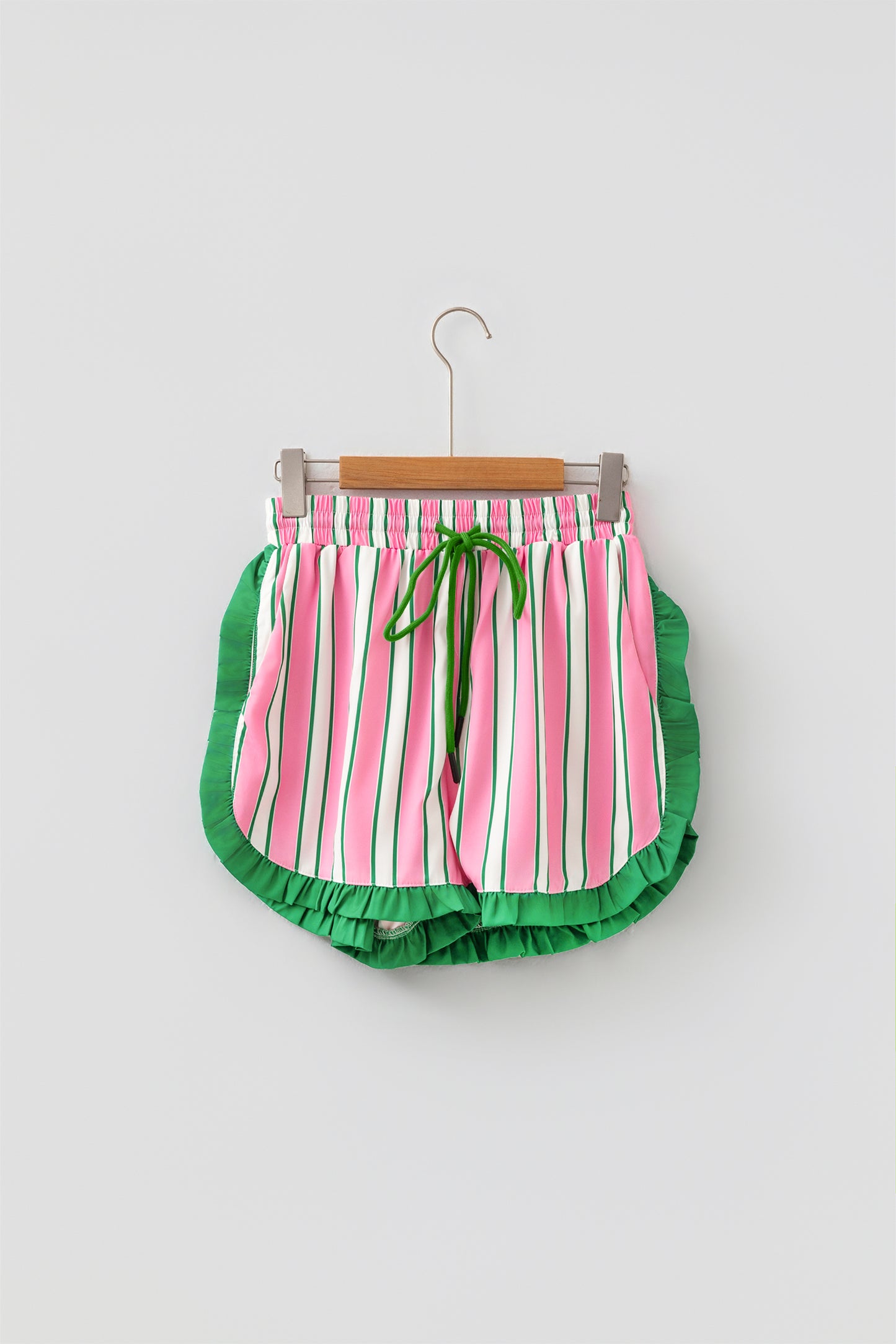 Pink stripe ruffle trim shorts - front flat lay on hanger showing full stripe pattern and ruffle hem