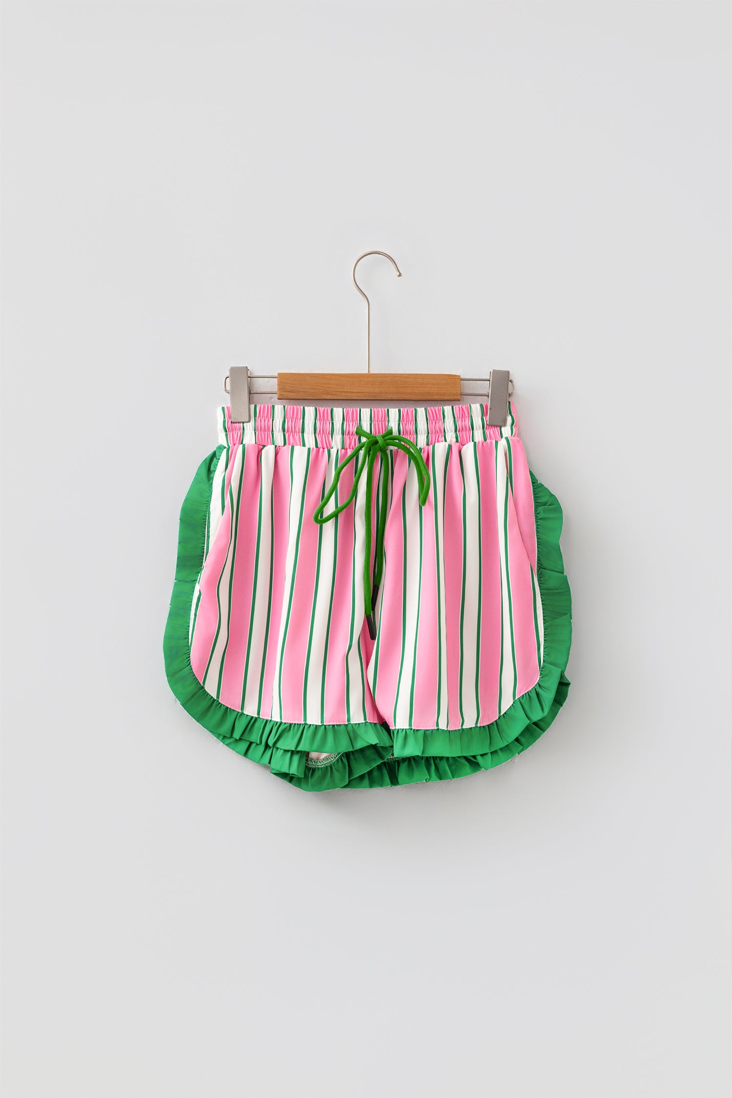 Pink stripe ruffle trim shorts - front flat lay on hanger showing full stripe pattern and ruffle hem