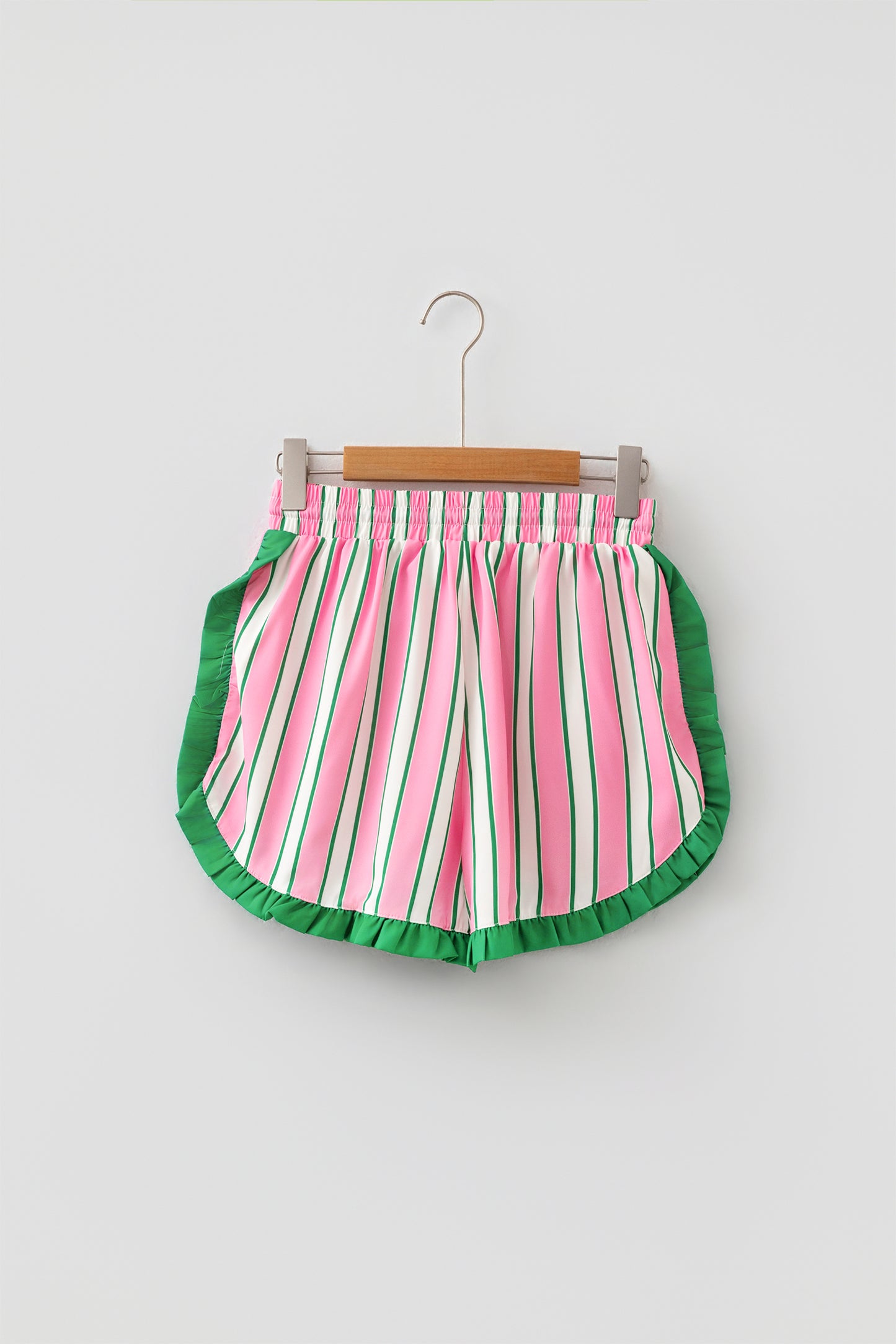 Pink stripe ruffle trim shorts - back flat lay on hanger showing smocked waistband and curved ruffle hem