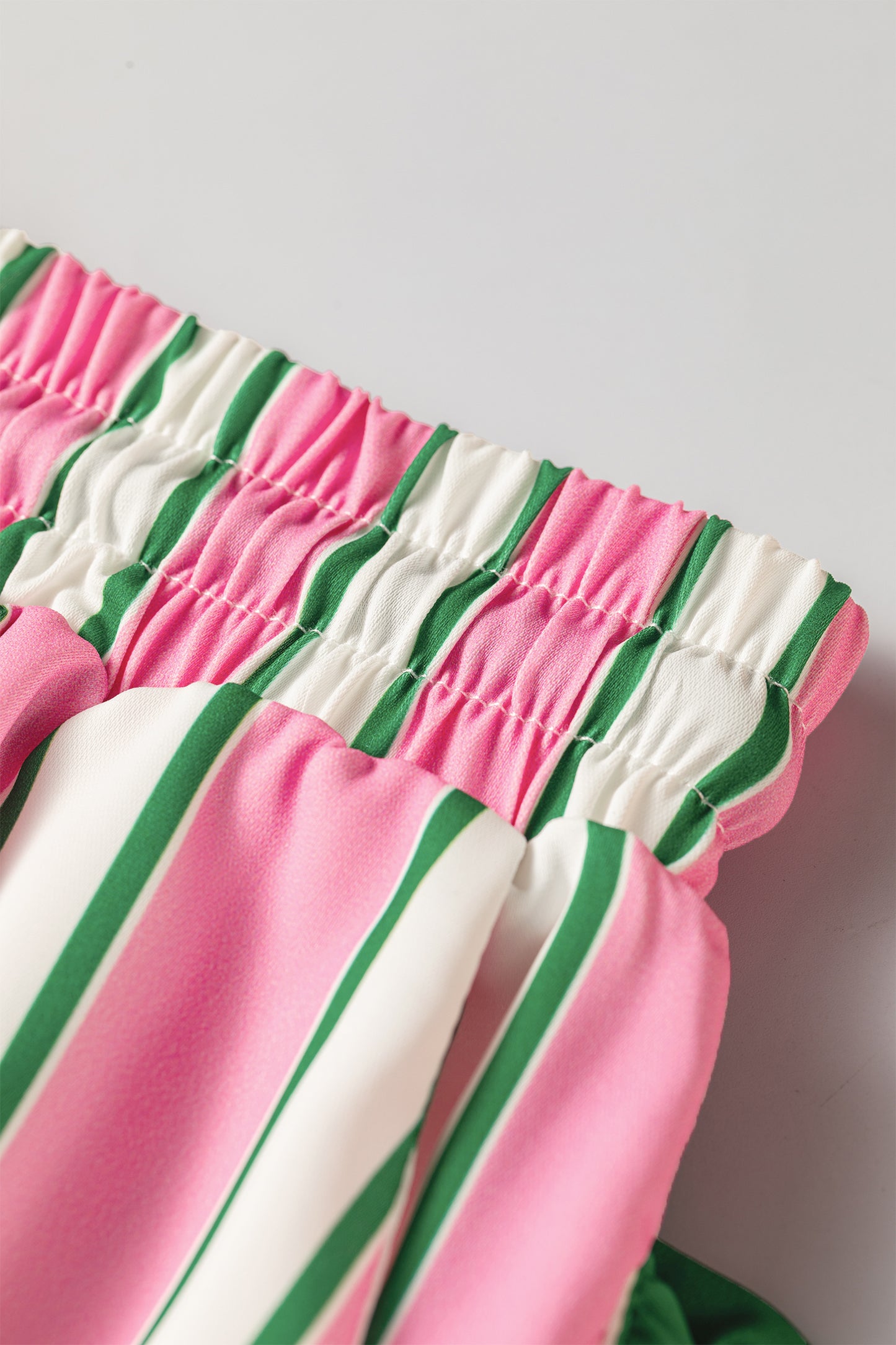 Pink stripe ruffle trim shorts - angled view on model showing side pocket and ruffle trim