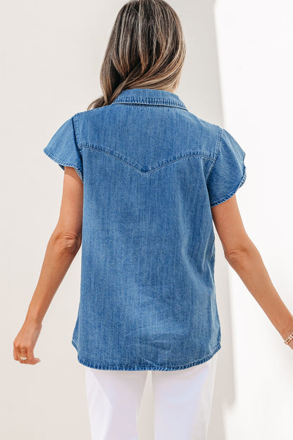 Dusk blue ruffle sleeve denim shirt - front close-up on model showing ruffle cap sleeve and pointed collar