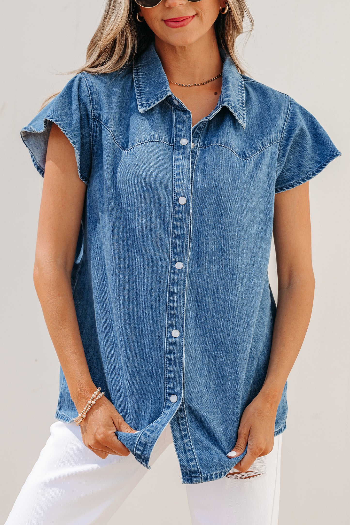 Dusk blue ruffle sleeve denim shirt - front on model with white jeans showing tucked styling