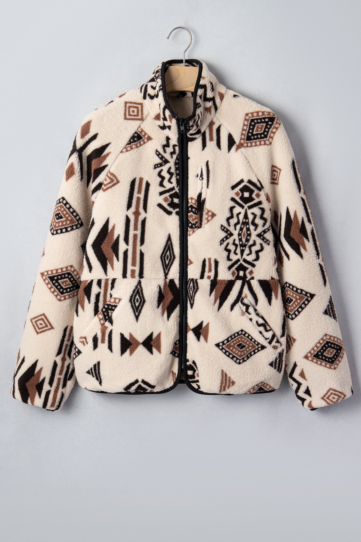 Beige geometric fleece zip-up jacket styled with denim