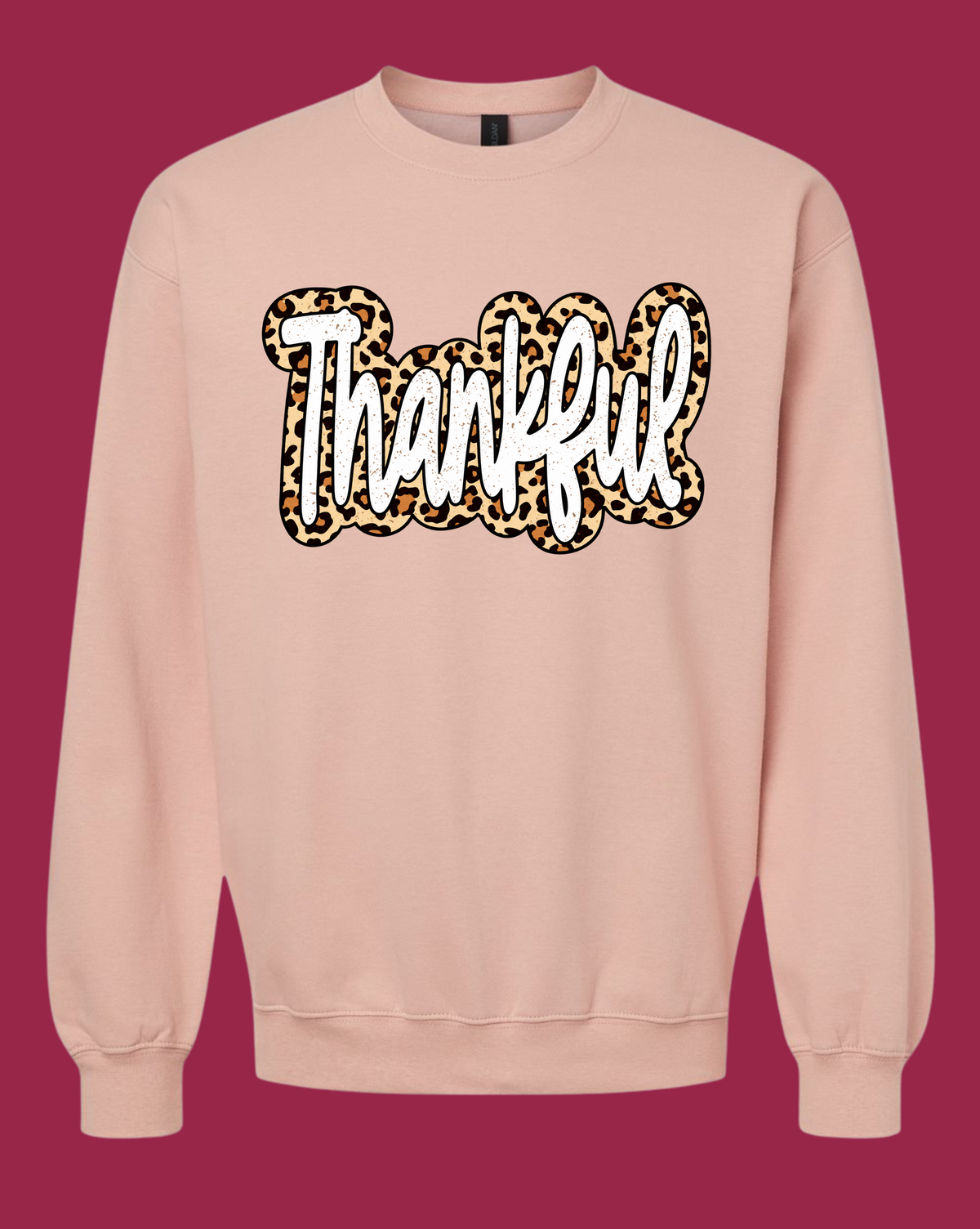 Blush-toned Gildan crewneck sweatshirt with white Thankful script and leopard-print border