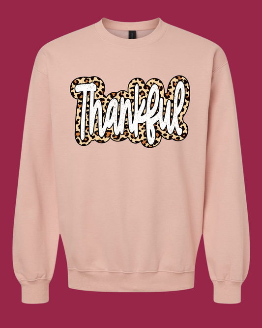 Blush-toned Gildan crewneck sweatshirt with white Thankful script and leopard-print border